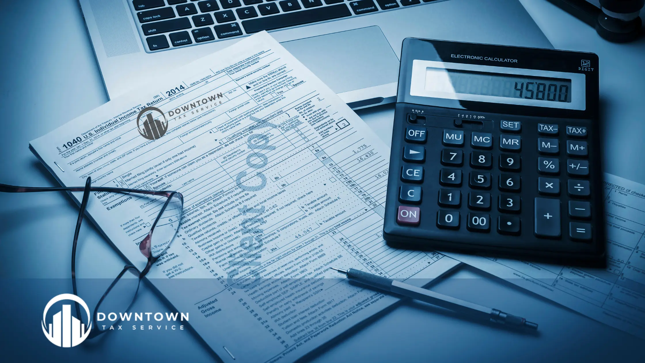 A taxpayer reviewing DIY tax software with tax documents on a desk